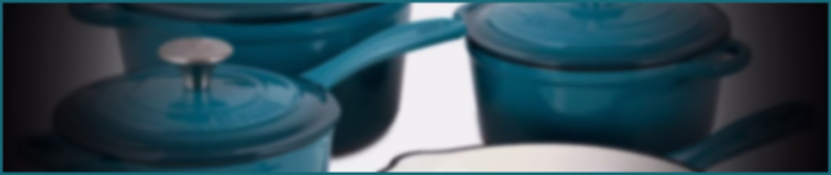 A blurred effect image displaying a selection of blue enamelled cast iron cookware.