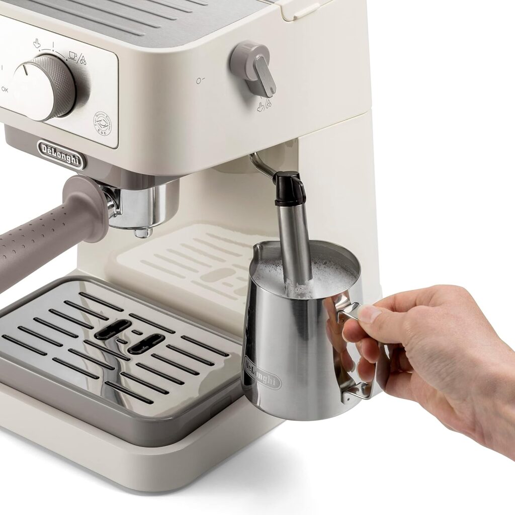 espresso coffee machine showing milk frother in use