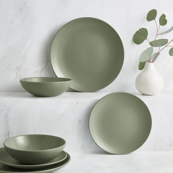 Sage coloured dinner plate, tea plate and bowl with a white bud vase on grey background