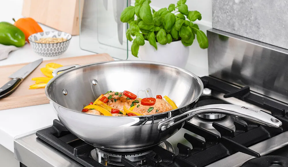 Procook Proffessional Stainless Steel Wok cooking food on a stove-top.